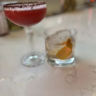 two cocktails on a bar