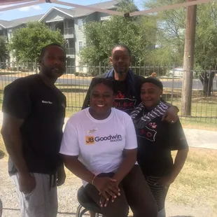 a group of people standing under a tent