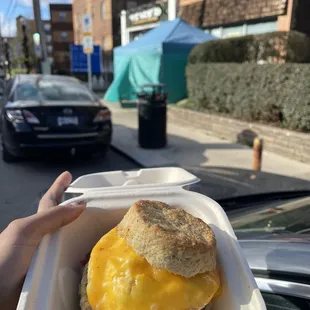 Sausage egg and cheese biscuit with teal tent in background