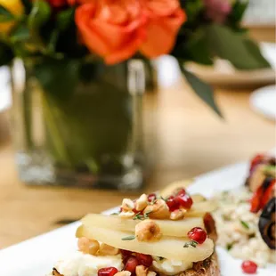 a plate of toast with fruit and nuts