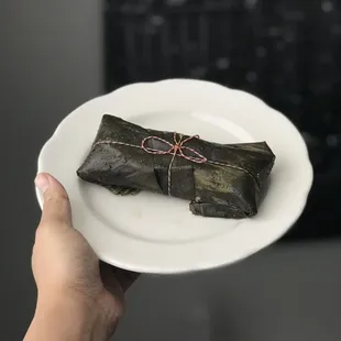 Tamale wrapped in banana leaves.