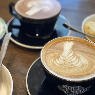 two cups of coffee and a plate of pastries