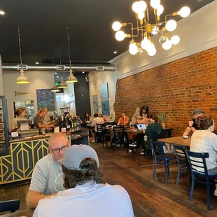people sitting at tables in a coffee shop