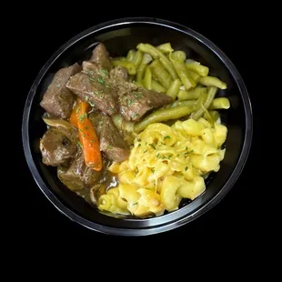 Soul bowl with beef tips braised in red wine over soul rice or mashed potatoes, mac &amp; cheese and green beans.