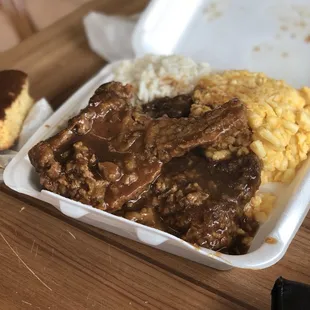 Smothered pork chops, white rice, and Mac and cheese.