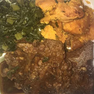Smothered pork chops, yams, collard greens