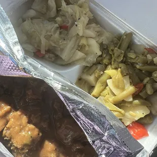 Veggie plate with dressing, cabbage, and green beans.