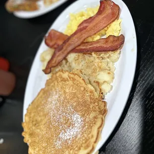 Pancake, mashed potatoes, bacon, and eggs