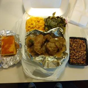 Smothered chicken, black eyed peas, collard&apos;s, Mac n cheese, cornbread, rice on the side not pictured.