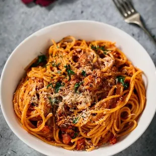 a bowl of spaghetti with meat and sauce