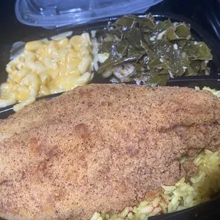 Catfish over yellow rice with greens and Mac and cheese.