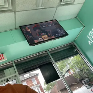 a flat screen tv mounted above a window