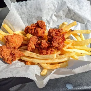 Alligator fritters atop many, many fries