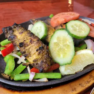 a plate of grilled meat and vegetables