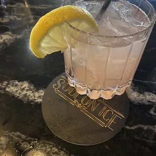 a drink with a lemon wedge