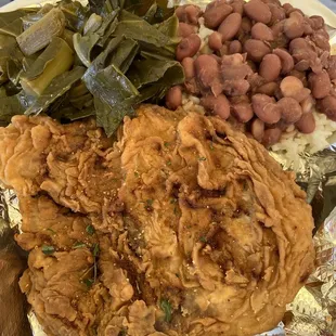 Fried pork chop meal with collard greens and Red Beans and Rice