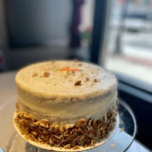 a frosted cake on a glass plate