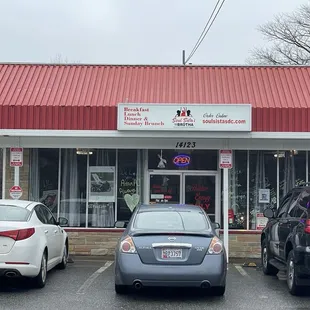 two cars parked in front of a restaurant