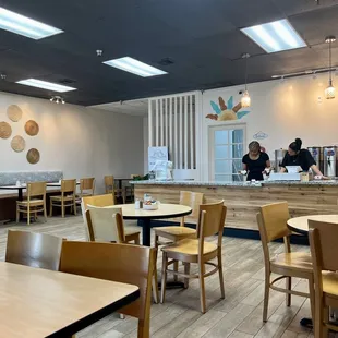 a dining area with tables and chairs