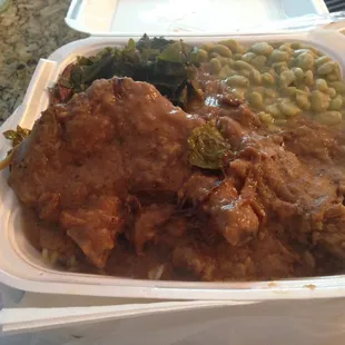 Smothered pork chops with collard greens and Lima beans