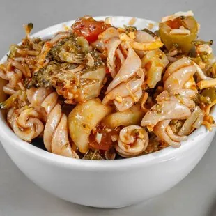 Pasta salad. Rotini noodles, broccoli, tomatoes, green olives, shredded cheese, and cucumbers tossed in Italian dressing.