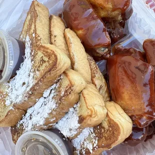 a variety of pastries in a styrofoam container