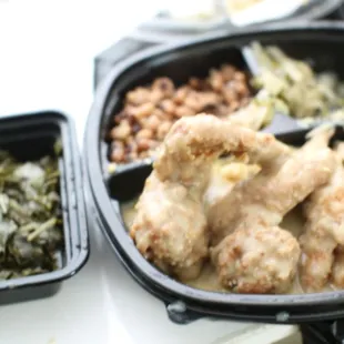 Smothered wings with sides and an extra portion of greens.