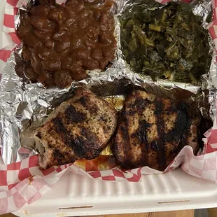 Grilled pork chop plate with red beans and rice and greens