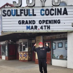 a man standing in front of a marquee