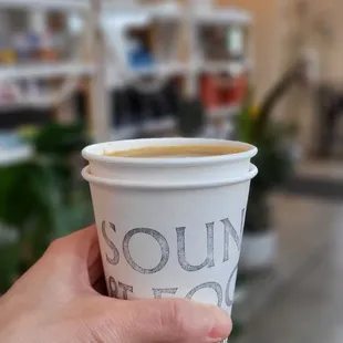 a hand holding a cup of coffee