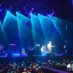a man playing a guitar on stage