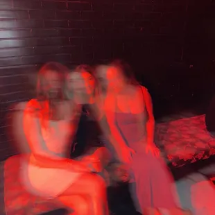 two women sitting on a bed
