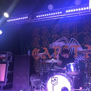 a man playing drums on stage