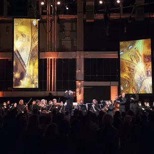 a man on stage in front of a crowd