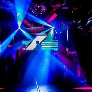 a stage with lights and a dj