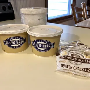 two cups of ice cream and a bag of cookies