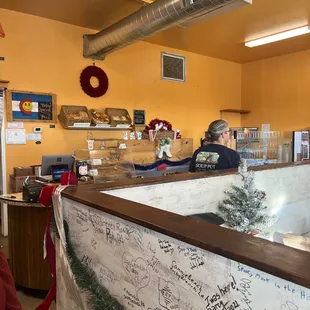 a woman sitting at a counter in a restaurant