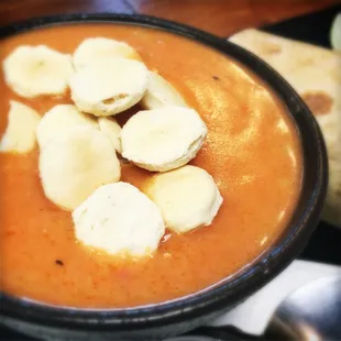 a bowl of soup with banana slices