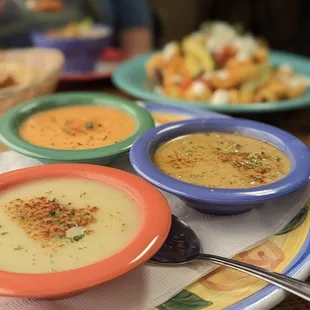 three bowls of soup on a plate