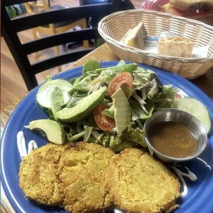 a blue plate with a salad and fried chicken