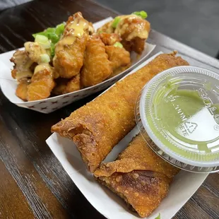 Philly egg roll  and chicken wings. The green sauce is amazing !
