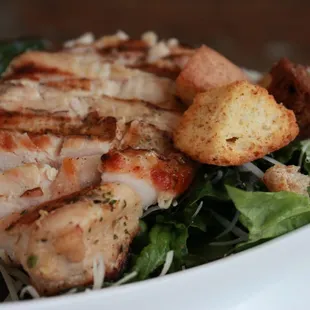 Chicken Caesar 
Grilled Halal  Chicken breast on a bed of crisp red leaf romaine lettuce top with  parmesan cheese