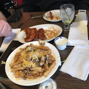 Loaded fries with cheese and bacon. Side of ranch to dip. Chicken tenders coated with wing sauce.