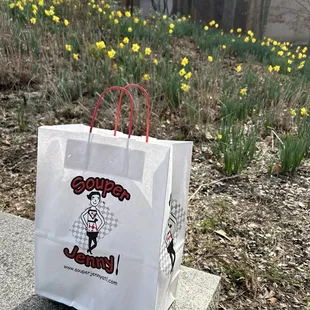 a paper bag sitting on a bench