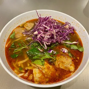 a bowl of soup with meat and vegetables