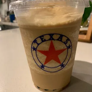 a cold beverage in a plastic cup