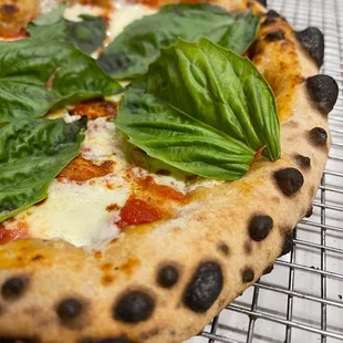 a freshly baked pizza with basil leaves