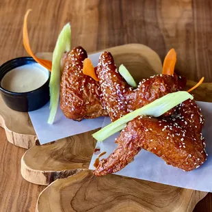 a plate of chicken wings with dipping sauce