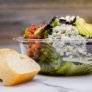 a salad with avocado and blue cheese