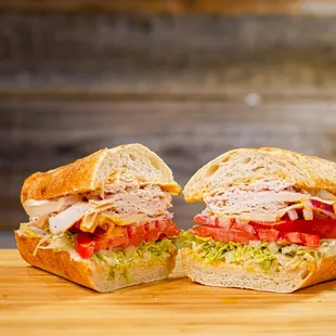 two halves of a sandwich on a cutting board
